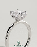 Kynora CJ 2ct elongated cushion claw solitaire engagement ring with petal gallery and accented tiara detail.