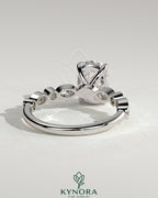 Kynora CJ 2ct elongated cushion solitaire engagement ring with round and marquise bezel accent stones, elegant and sparkling.