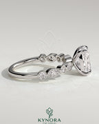 Kynora CJ 2ct elongated cushion claw solitaire engagement ring with round-marquise bezel accent stones in sterling silver.