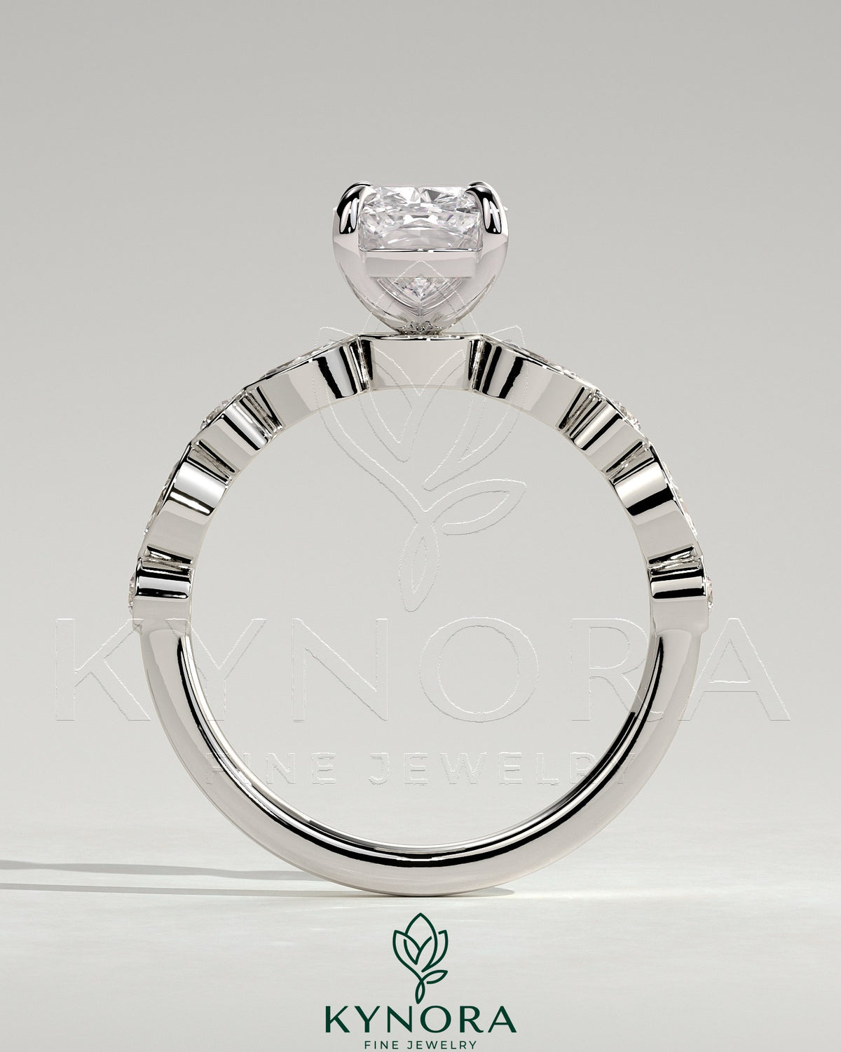 Kynora CJ 2ct elongated cushion claw solitaire engagement ring with round and marquise bezel accent stones on a silver band