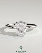 Kynora CJ 2ct elongated cushion solitaire engagement ring with wrap-around hidden halo, featuring a sparkling central stone.