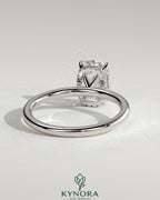 Kynora CJ 2ct elongated cushion cut solitaire engagement ring with hidden halo and wrap-around design in white gold.