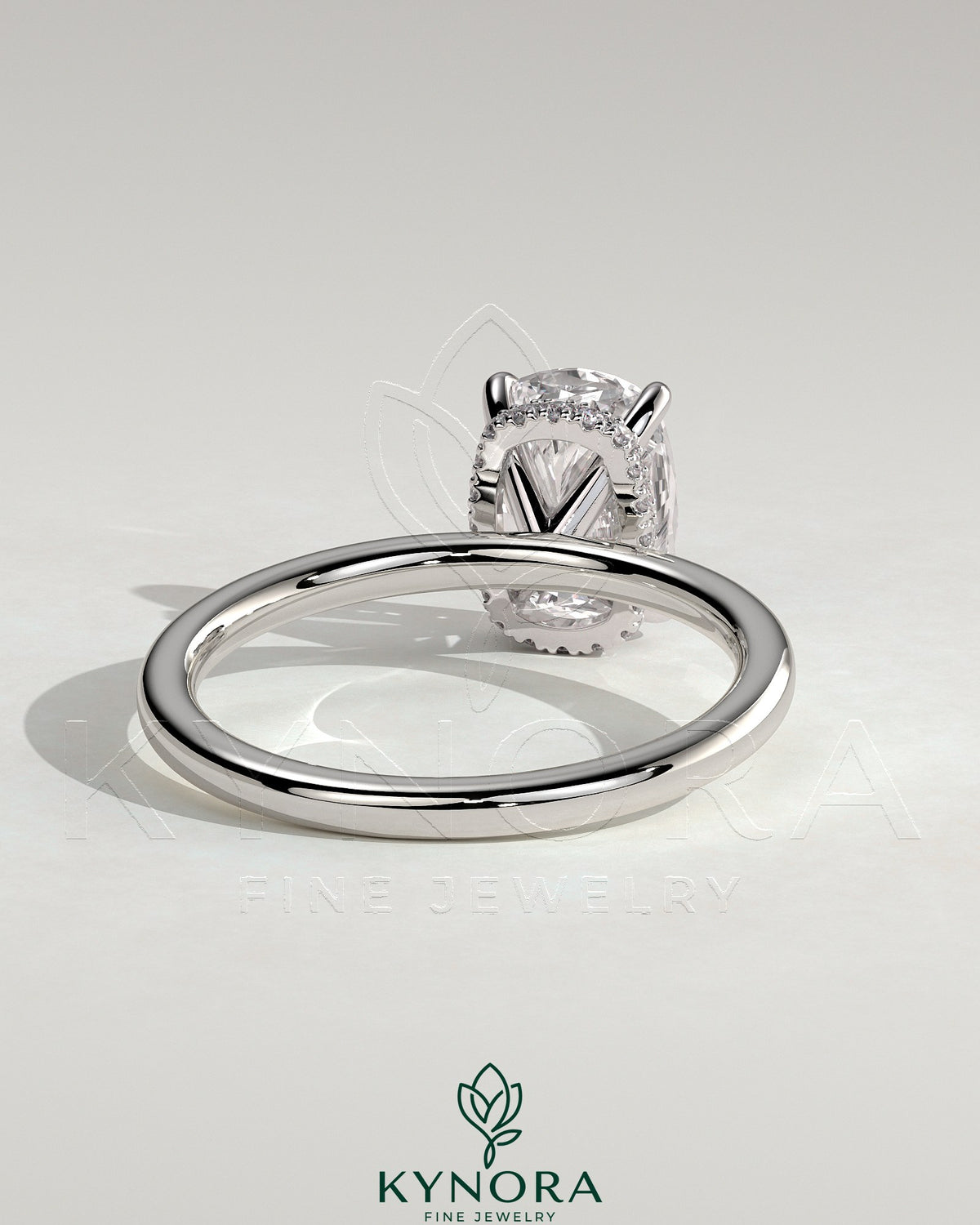 Kynora CJ 2ct elongated cushion cut solitaire engagement ring with hidden halo and wrap-around design in white gold.