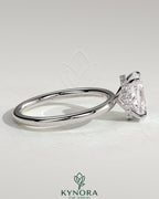 Kynora CJ 2ct elongated cushion cut solitaire engagement ring with wrap-around hidden halo setting and intricate band design.