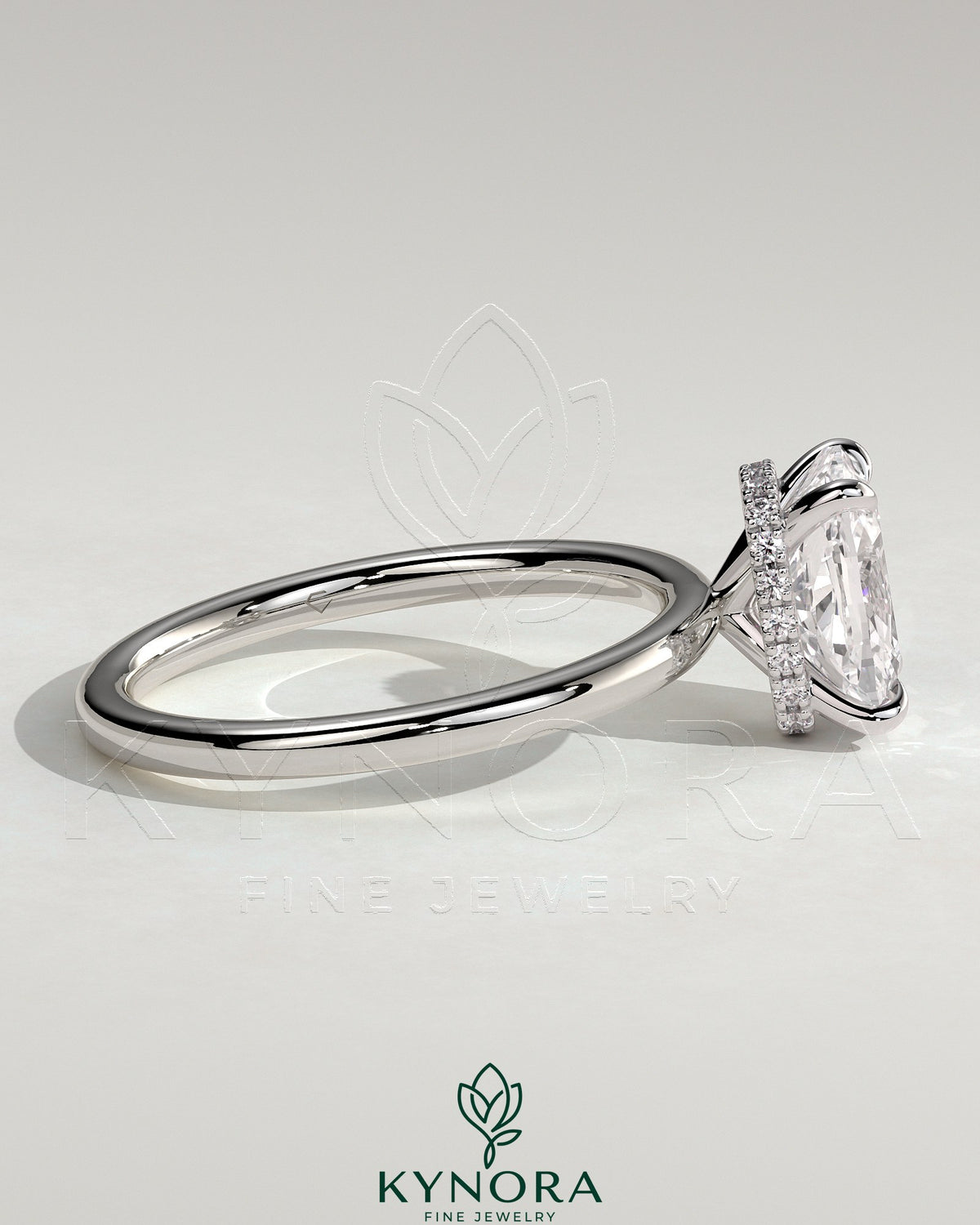 Kynora CJ 2ct elongated cushion cut solitaire engagement ring with wrap-around hidden halo setting and intricate band design.