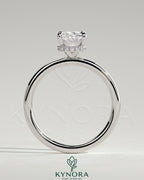 Kynora CJ 2ct elongated cushion claw solitaire engagement ring with wrap-around hidden halo, showcasing elegant diamond setting.