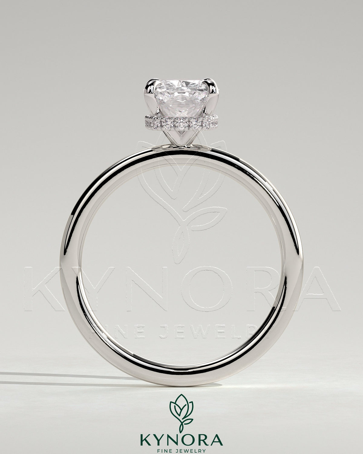 Kynora CJ 2ct elongated cushion claw solitaire engagement ring with wrap-around hidden halo, showcasing elegant diamond setting.