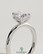 Kynora CJ 2ct elongated cushion double claw solitaire engagement ring with hidden halo, featuring a sparkling diamond setting.