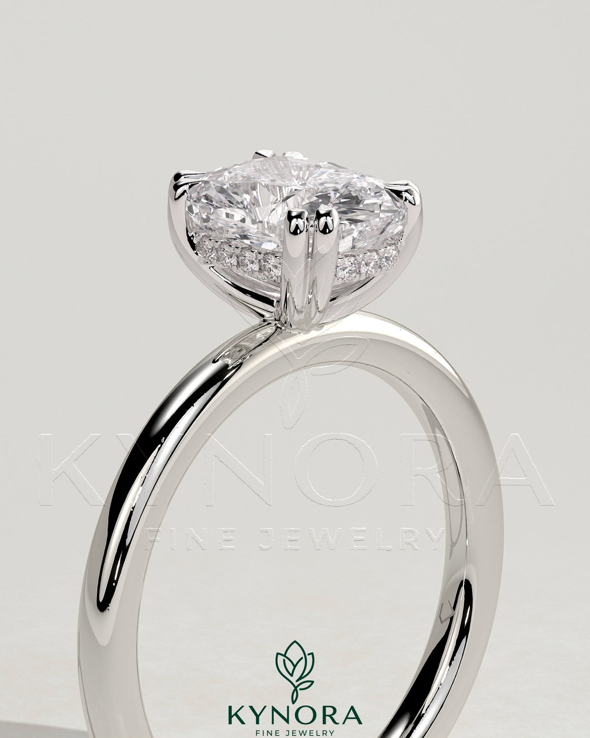 Kynora CJ 2ct elongated cushion double claw solitaire engagement ring with hidden halo, featuring a sparkling diamond setting.
