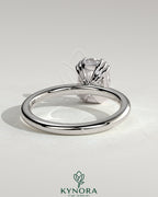 Kynora CJ 2ct elongated cushion triple claw solitaire engagement ring with a sparkling center diamond and sleek band.