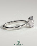 Kynora CJ 2ct elongated cushion cut diamond solitaire engagement ring with triple claw setting on a sleek band