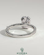 Kynora CJ 2ct elongated cushion solitaire engagement ring with triple claw setting and pavé band, crafted in elegant gold.