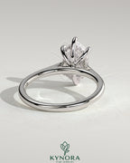 Kynora CJ 2ct elongated hexagon solitaire engagement ring with hidden halo and cathedral high setting, showcasing intricate design details.