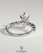 Kynora CJ 2ct elongated hexagon claw solitaire engagement ring with marquise and round accent stones, showcasing elegant diamond jewelry.