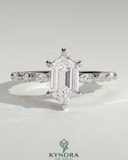 Kynora CJ 2ct elongated hexagon claw solitaire engagement ring with marquise and round accent stones, showcasing detailed craftsmanship.