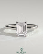 Kynora CJ 2-carat emerald claw solitaire engagement ring with a single emerald-cut diamond on a sleek band