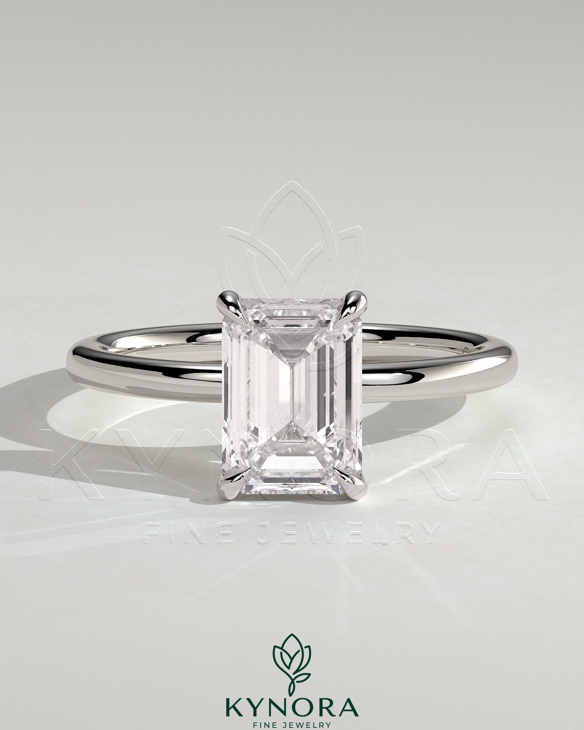 Kynora CJ 2-carat emerald claw solitaire engagement ring with a single emerald-cut diamond on a sleek band