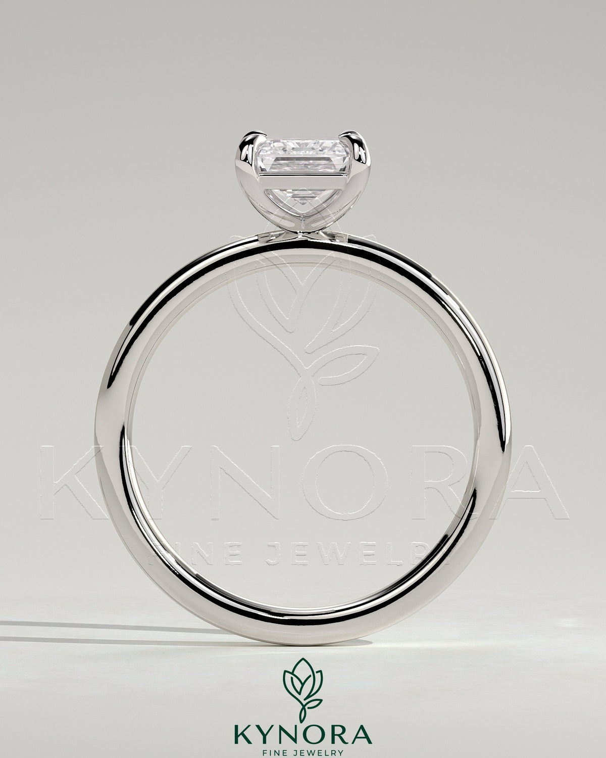 Kynora CJ 2ct emerald claw solitaire engagement ring with a central emerald-cut gemstone and elegant band.