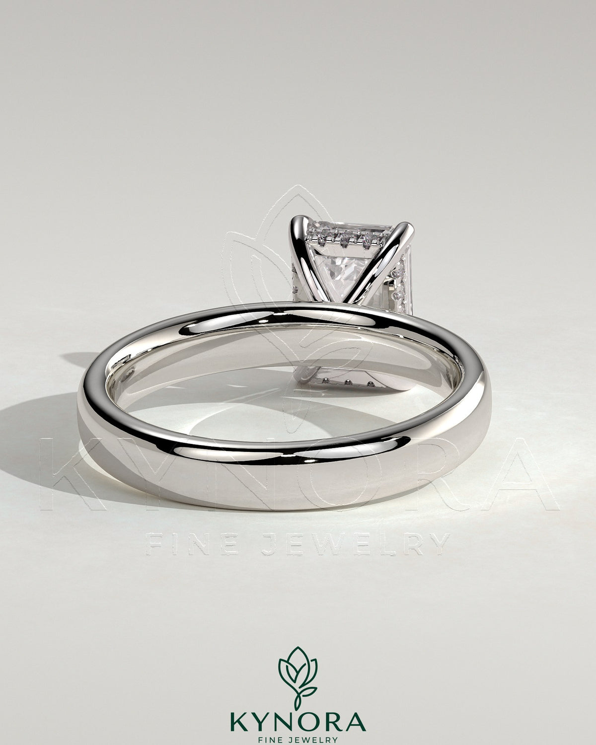 Kynora CJ 2ct emerald claw solitaire engagement ring with cigar band and hidden halo, showcasing detailed craftsmanship.