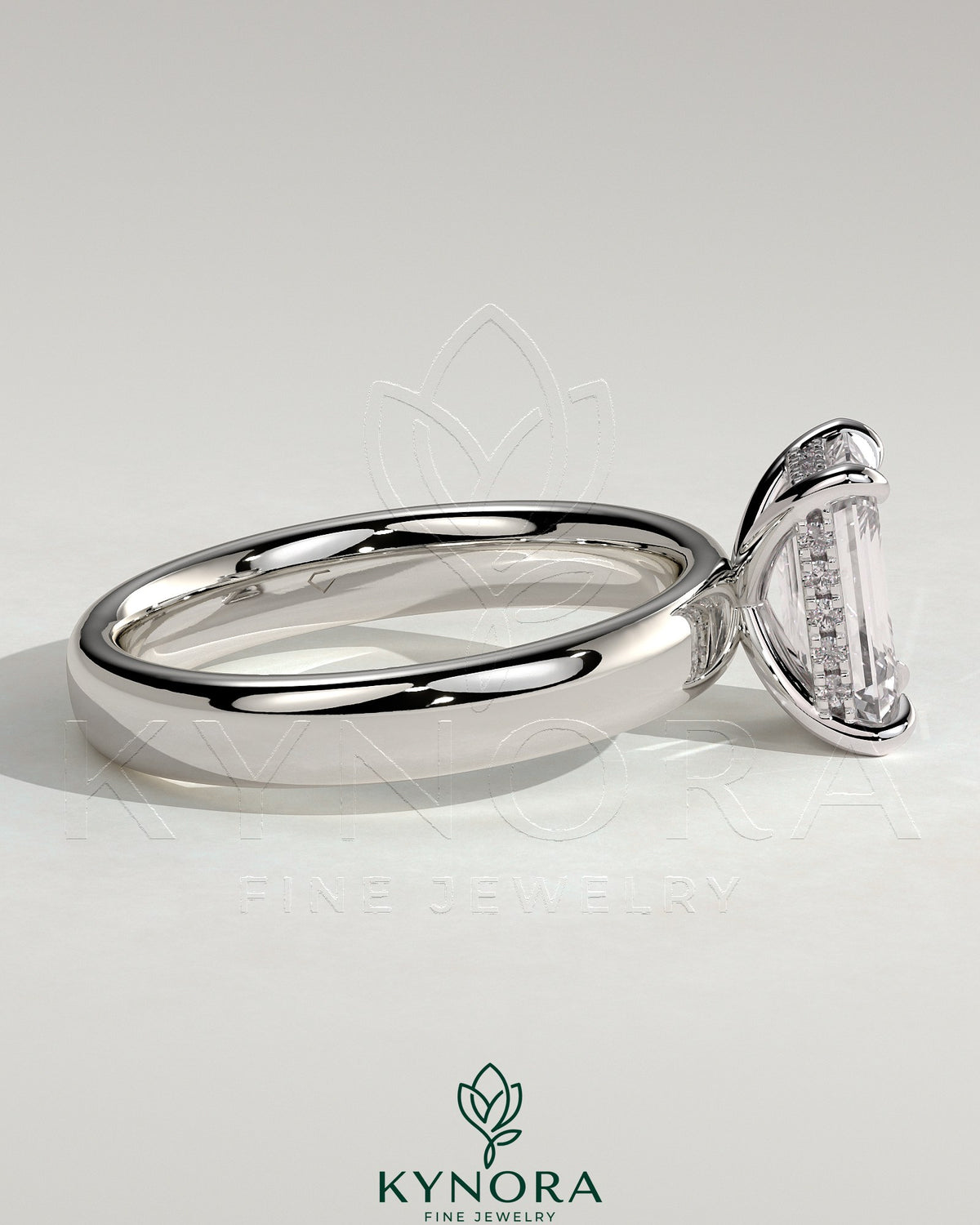 Kynora CJ 2ct emerald claw solitaire engagement ring with cigar band and hidden halo, showcasing intricate design details.