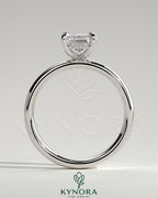 Kynora CJ 2ct emerald claw solitaire engagement ring with cigar band and hidden halo, featuring a sparkling emerald gemstone.