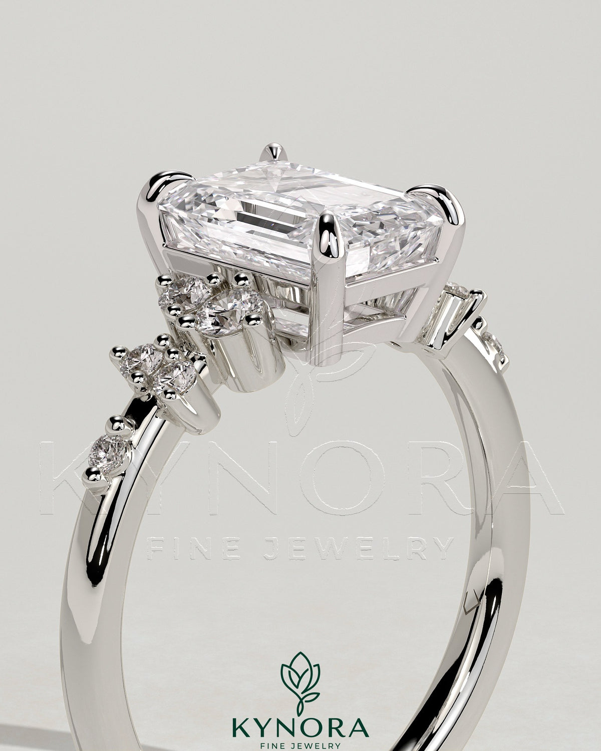 Kynora CJ 2ct emerald claw solitaire engagement ring with clustered round shoulder stones and intricate band design.