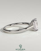 Kynora CJ 2ct emerald claw solitaire engagement ring with hidden halo and cathedral high setting, showcasing sparkling gemstone and intricate design.