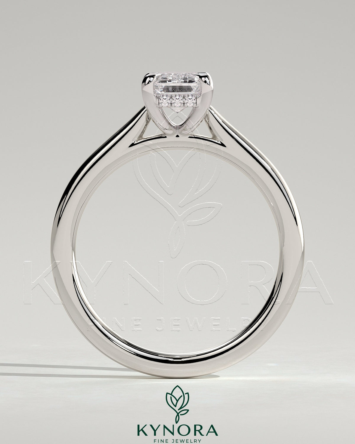 Kynora CJ 2ct emerald claw solitaire engagement ring with hidden halo and cathedral high setting, showcasing elegant jewelry design.
