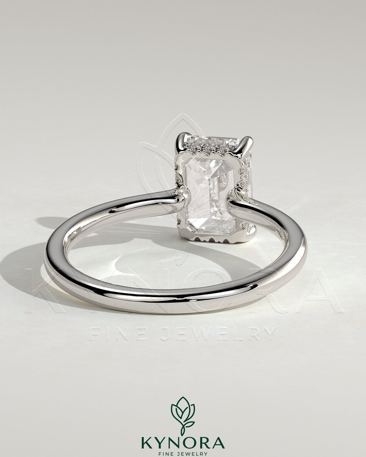 Kynora CJ 2ct emerald claw solitaire engagement ring with hidden halo and floating cathedral low setting, showcasing intricate design.