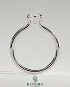 Kynora CJ 2ct emerald claw solitaire engagement ring with hidden halo and floating cathedral low setting, showcasing intricate design and sparkle.