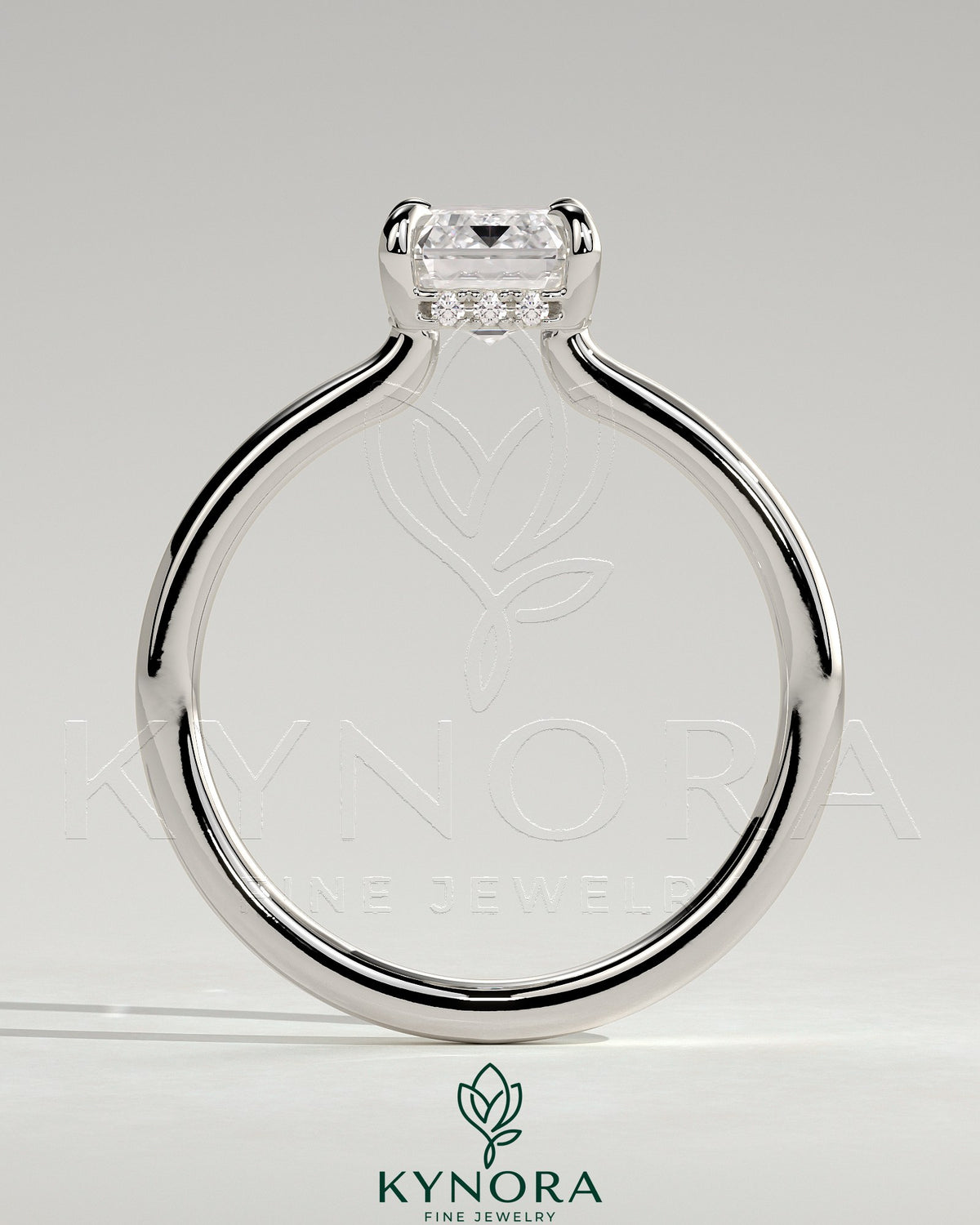 Kynora CJ 2ct emerald claw solitaire engagement ring with hidden halo and floating cathedral low setting, showcasing intricate design and sparkle.