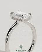 Kynora CJ 2ct emerald claw solitaire engagement ring with hidden halo and floating cathedral low setting, showcasing intricate design.