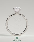 Kynora CJ 2ct emerald claw solitaire engagement ring with hidden halo and pavé band, showcasing intricate design and sparkling gemstone.