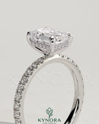 Kynora CJ 2ct emerald claw solitaire engagement ring with hidden halo and pave band, showcasing intricate design and sparkling gemstone.