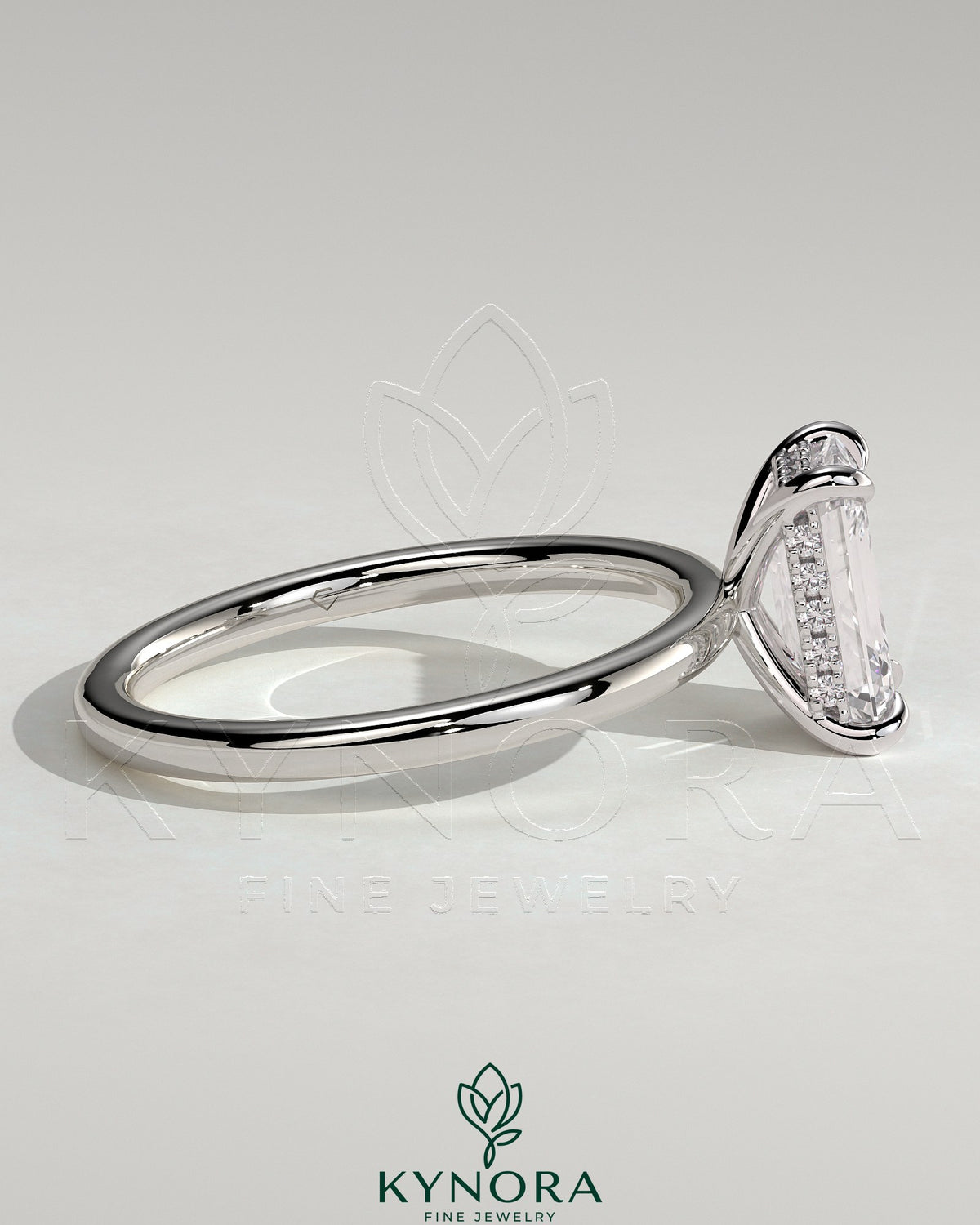 Kynora CJ 2ct emerald claw solitaire engagement ring with hidden halo, featuring a central emerald-cut gemstone and intricate band design.