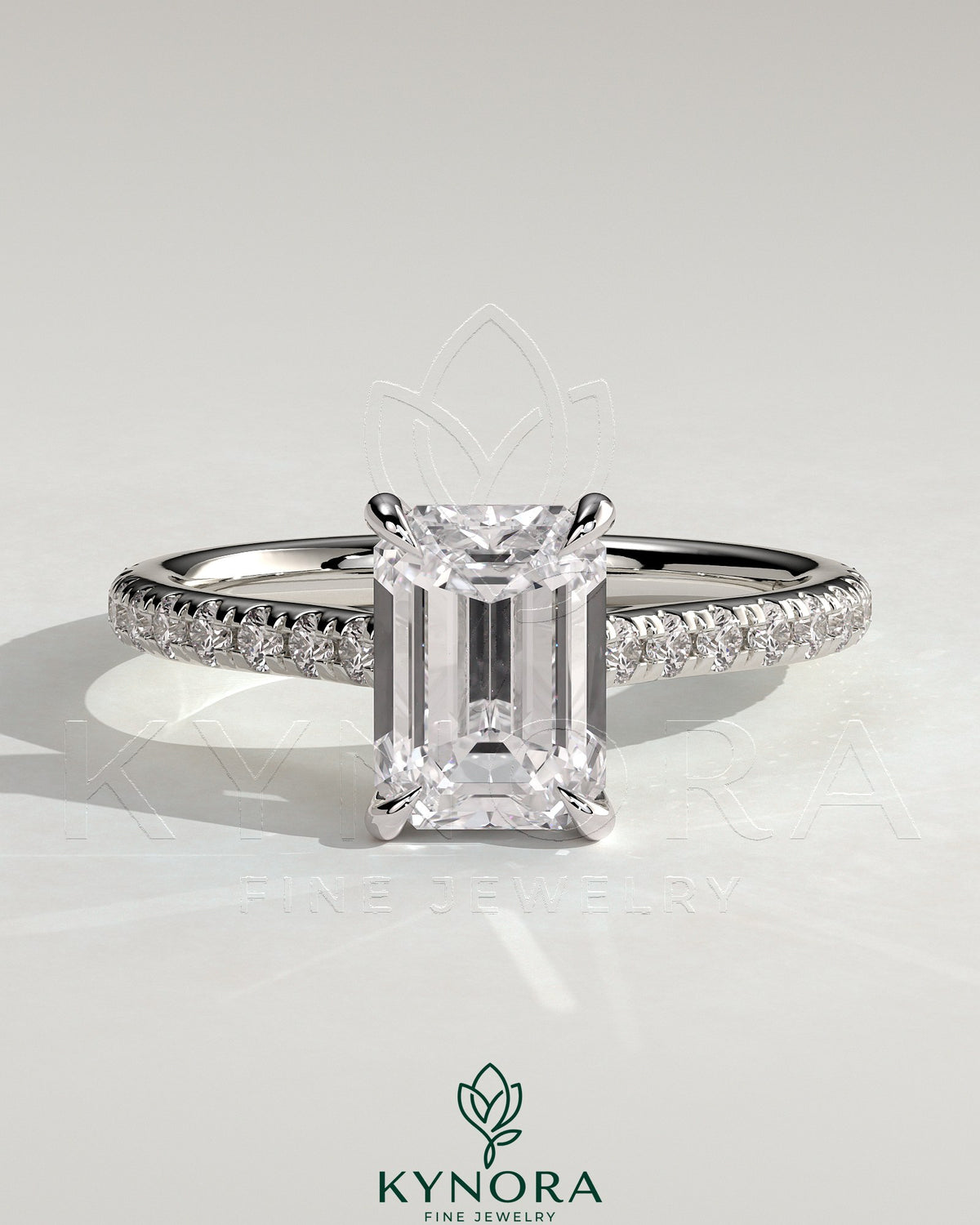 Kynora CJ 2ct emerald claw solitaire engagement ring with hidden halo, pave band, and cathedral high setting. Main image