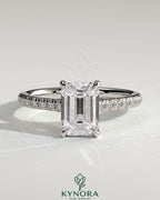 Kynora CJ 2ct emerald claw solitaire engagement ring with hidden halo, pave band, and cathedral high setting.