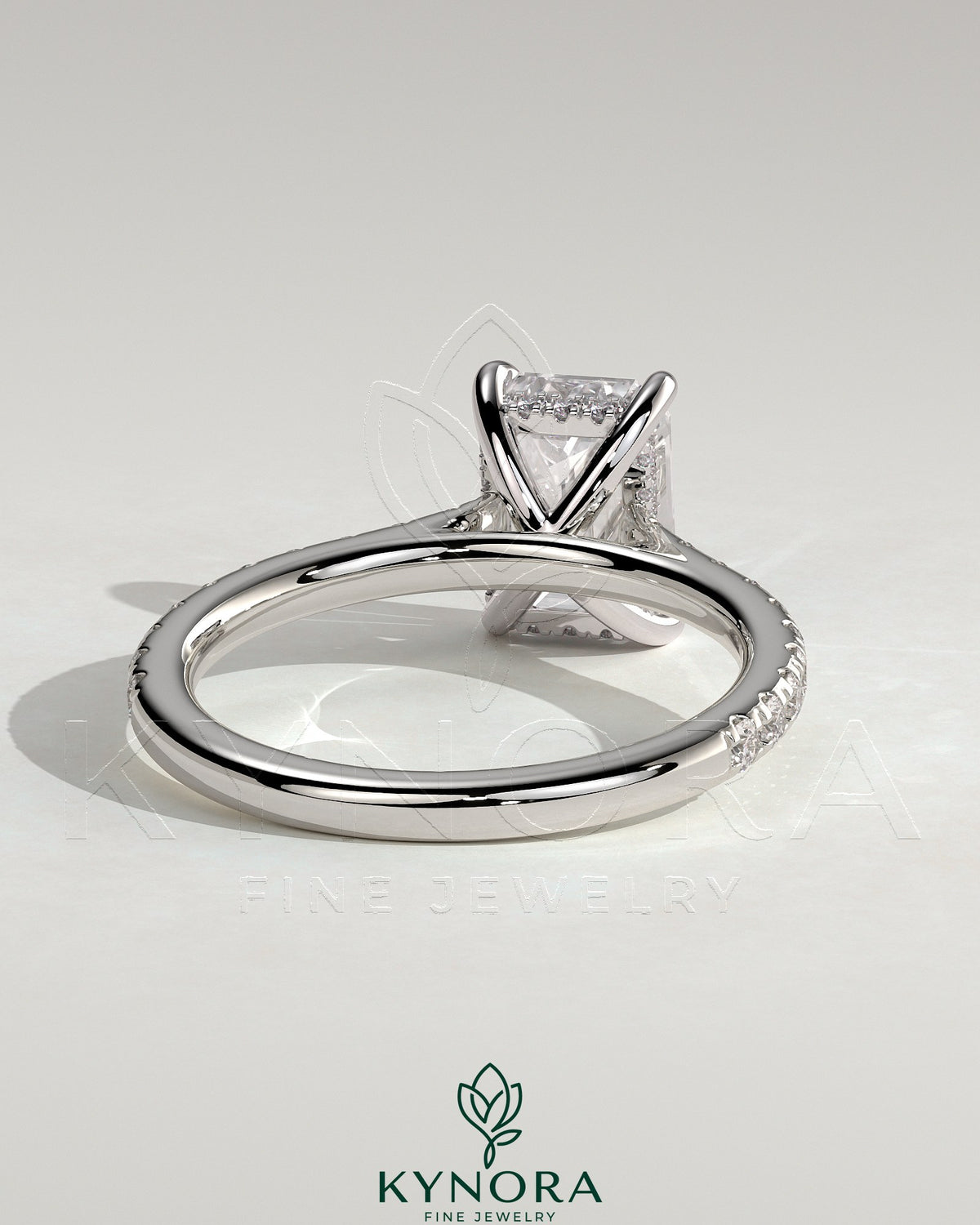 Kynora CJ 2ct emerald claw solitaire engagement ring with hidden halo, pave band, and cathedral high setting, showcasing fine craftsmanship.