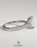 Kynora CJ 2ct emerald claw solitaire engagement ring with hidden halo, pave band, and cathedral high setting, showcasing elegant jewelry.