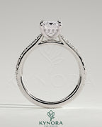 Kynora CJ 2ct emerald claw solitaire engagement ring with hidden halo, pave band, and cathedral high setting.
