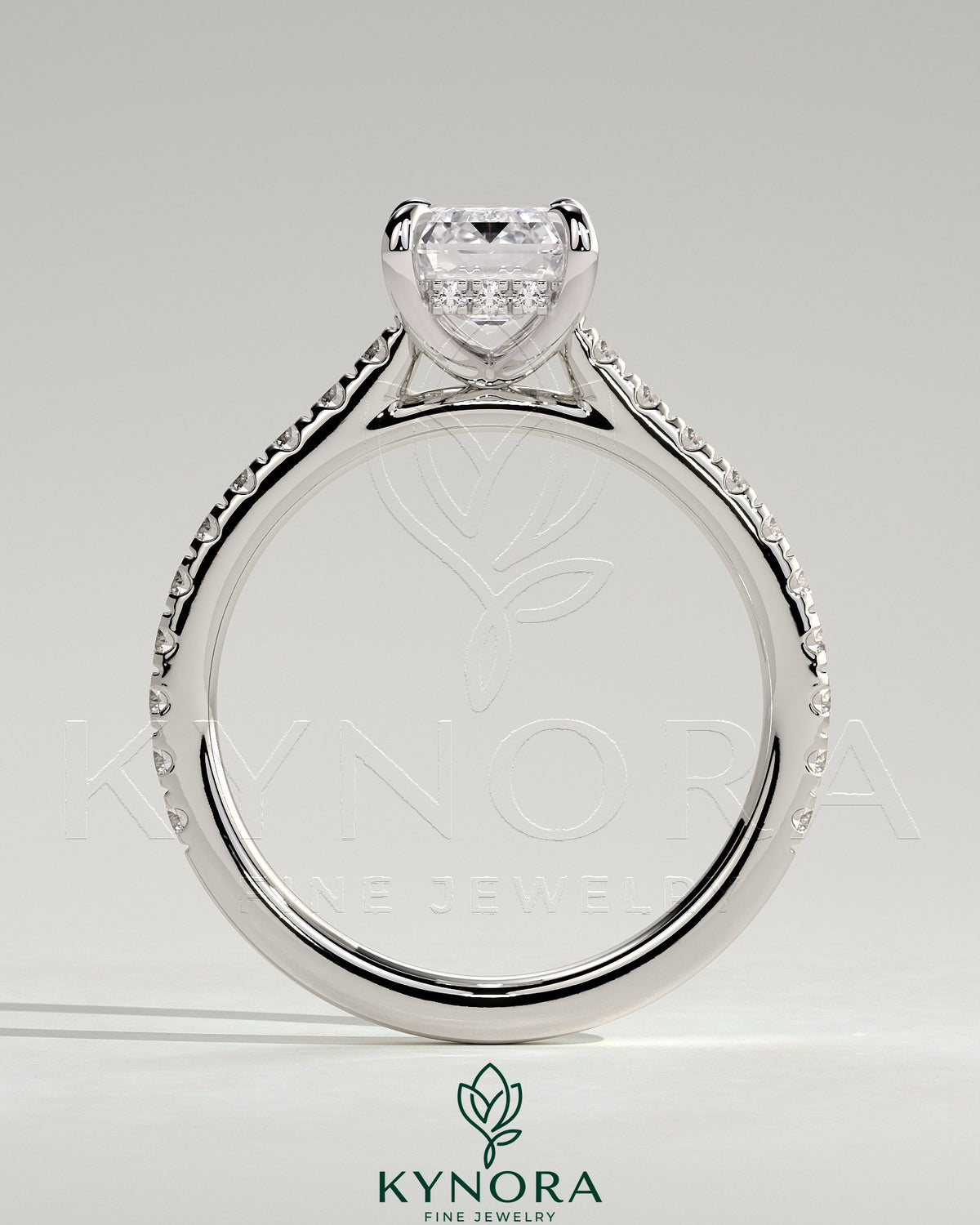 Kynora CJ 2ct emerald claw solitaire engagement ring with hidden halo, pave band, and cathedral high setting.
