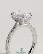 Kynora CJ 2ct emerald claw solitaire engagement ring with hidden halo, pave band, and cathedral high setting.