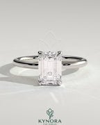 Kynora CJ 2ct emerald claw solitaire engagement ring with petal gallery, leaf accents, and cathedral setting.