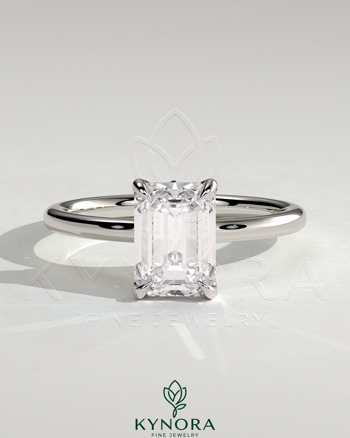 Kynora CJ 2ct emerald claw solitaire engagement ring with petal gallery, leaf accents, and cathedral setting.