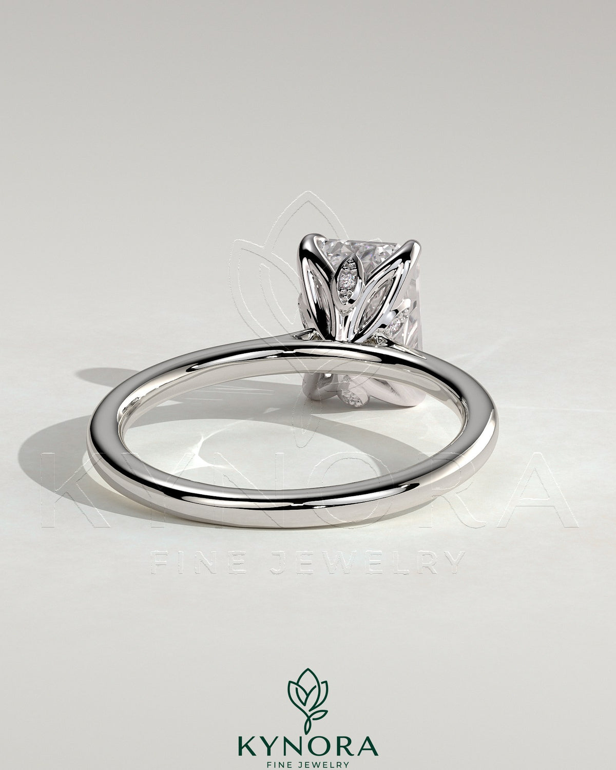 Kynora CJ 2ct emerald claw solitaire engagement ring with petal gallery, leaf accents, and cathedral setting in silver jewelry style.