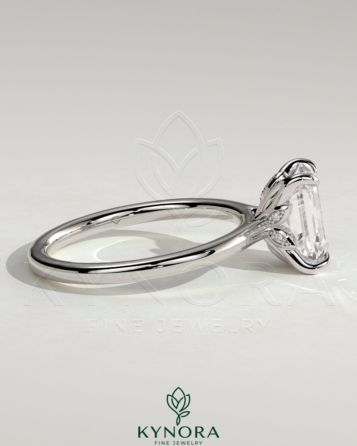 Kynora CJ 2ct emerald claw solitaire engagement ring with petal gallery, leaf accents, and cathedral setting.