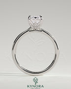 Kynora CJ 2ct emerald claw solitaire engagement ring with petal gallery, leaf accents, and cathedral setting.