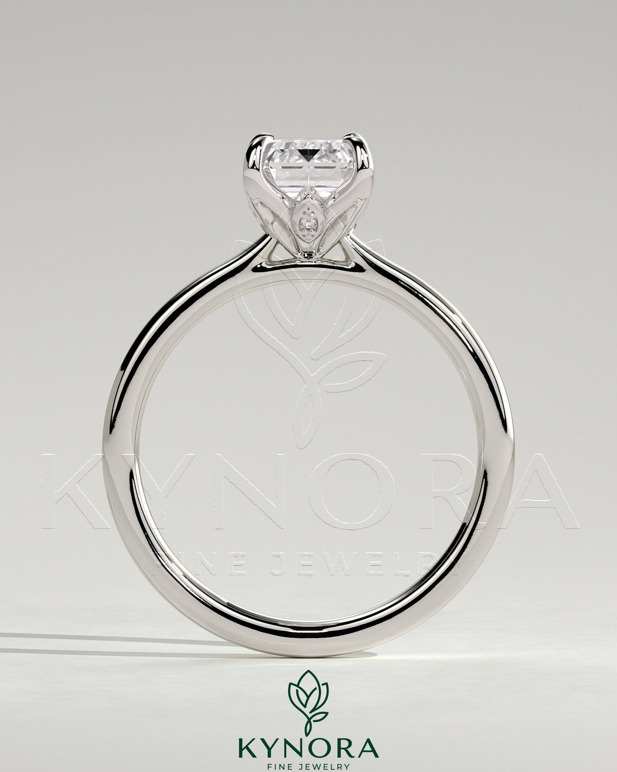 Kynora CJ 2ct emerald claw solitaire engagement ring with petal gallery, leaf accents, and cathedral setting.