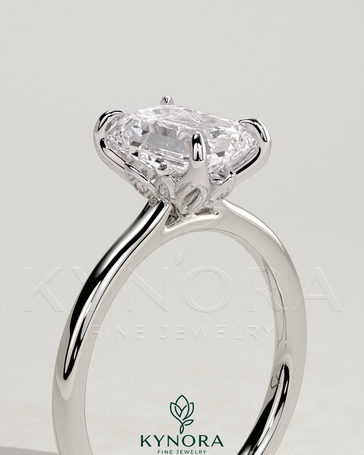 Kynora CJ 2ct emerald claw solitaire engagement ring with petal gallery, leaf accents, and cathedral setting.