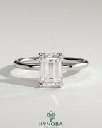 Kynora CJ 2ct emerald claw solitaire engagement ring with petal gallery and leaf accent detailing, crafted in elegant jewelry style.
